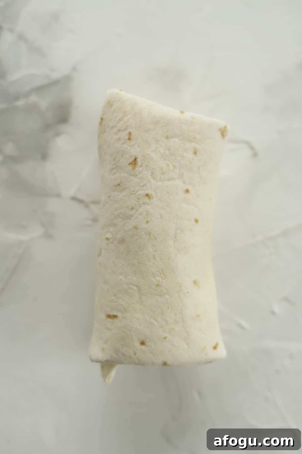 an uncooked strawberry cheesecake chimichanga