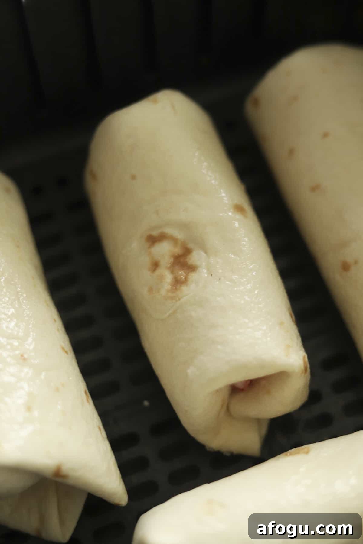 strawberry cheesecake chimichangas in an air fryer