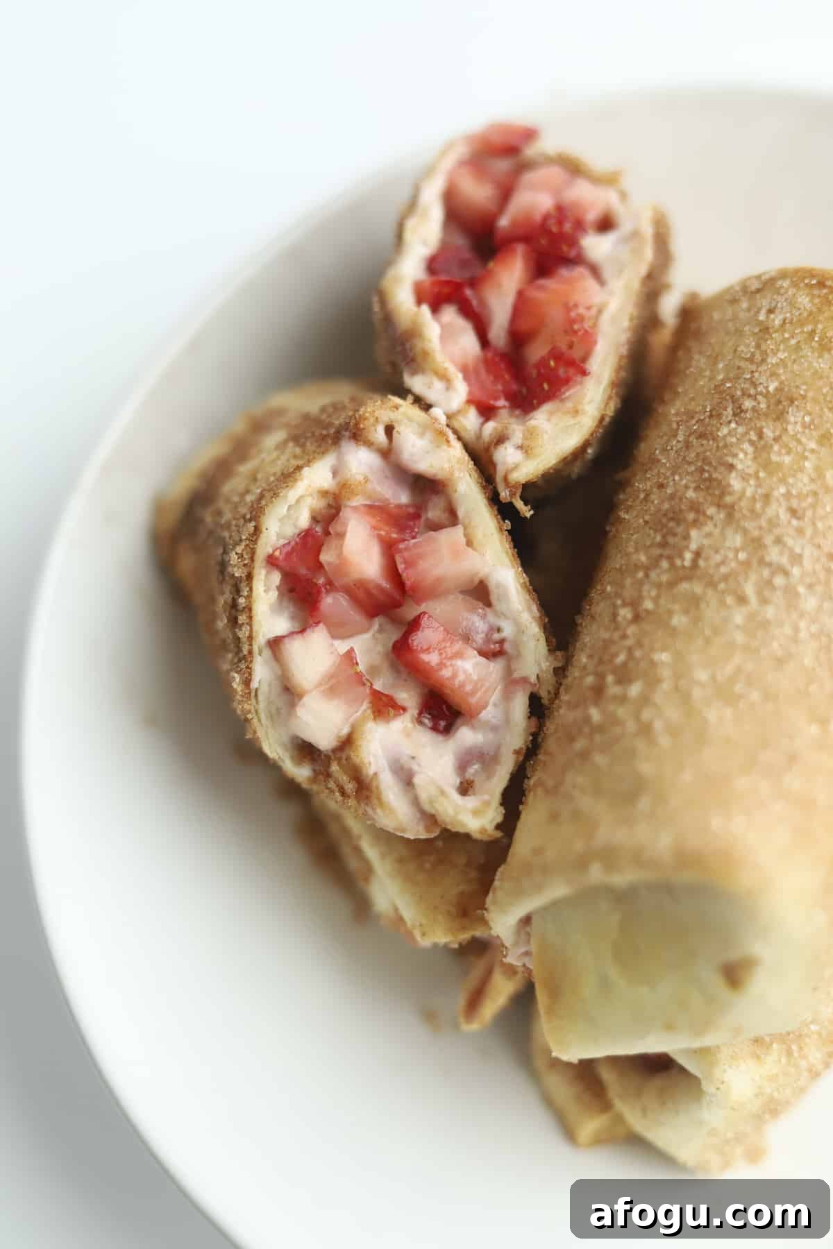opened stuffed chimichanga with fresh strawberries