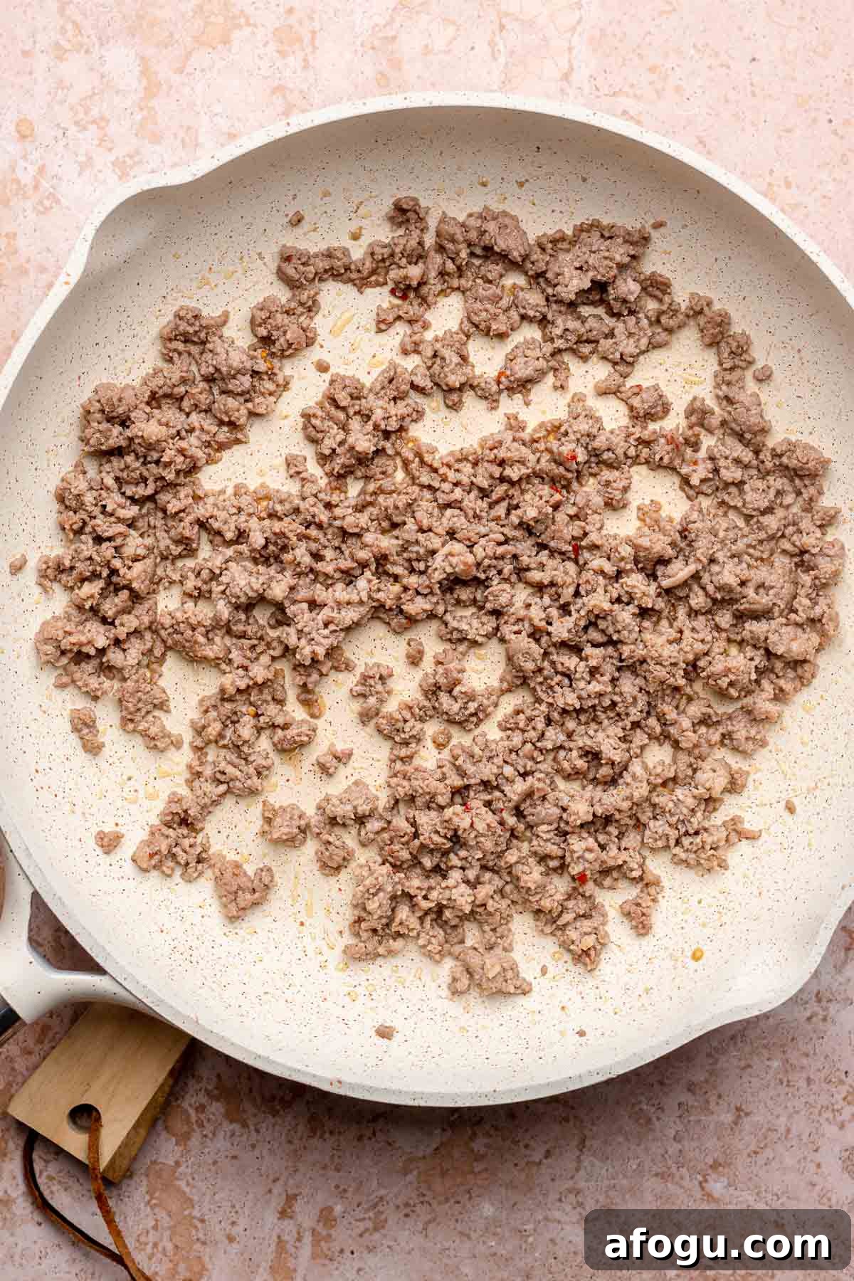 Ground sausage cooked in a pan.