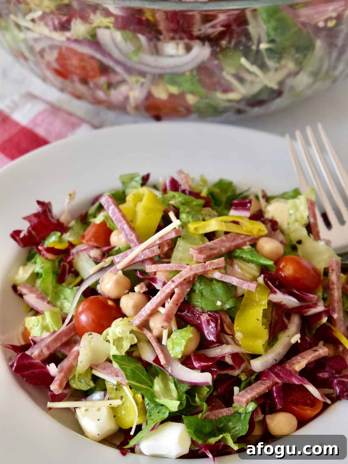 Italian Chopped Salad in a white bowl with a fork. 