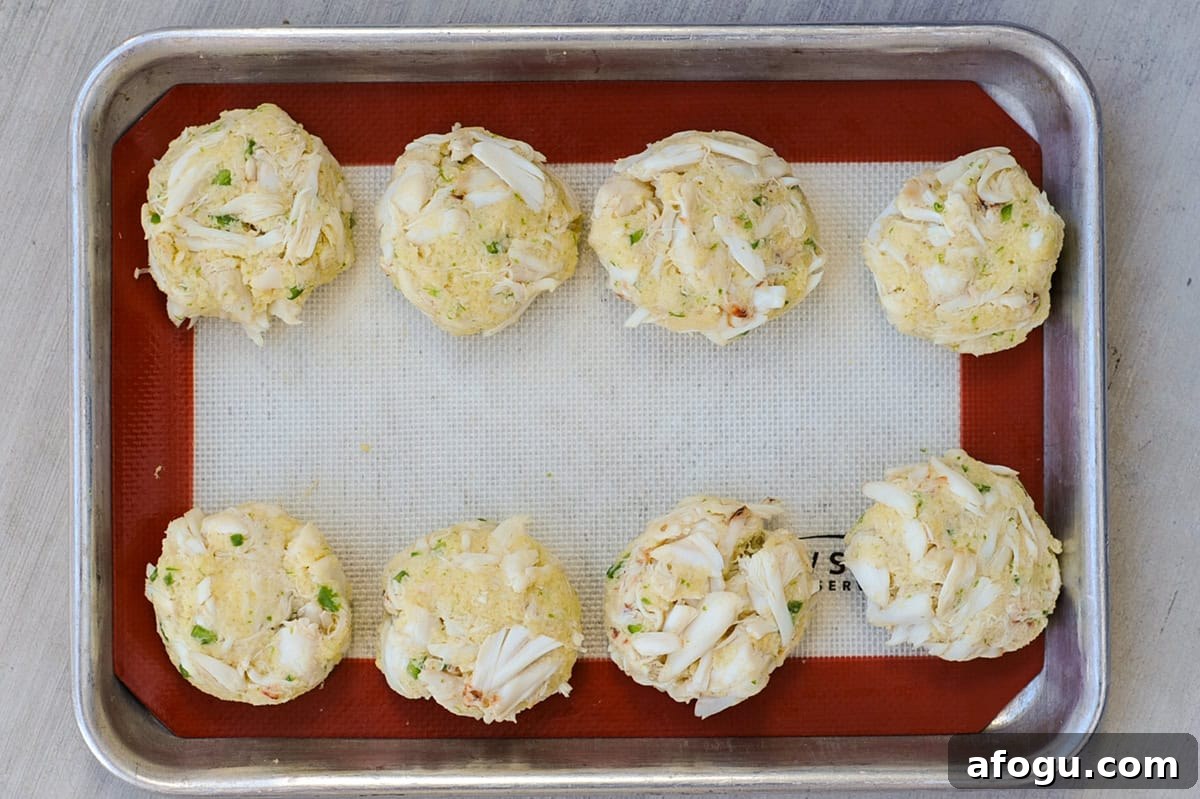 Formed crab cakes on tray.