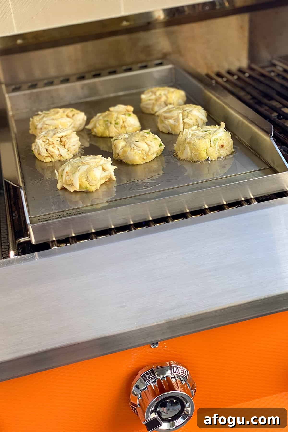 Crab cakes on griddle.