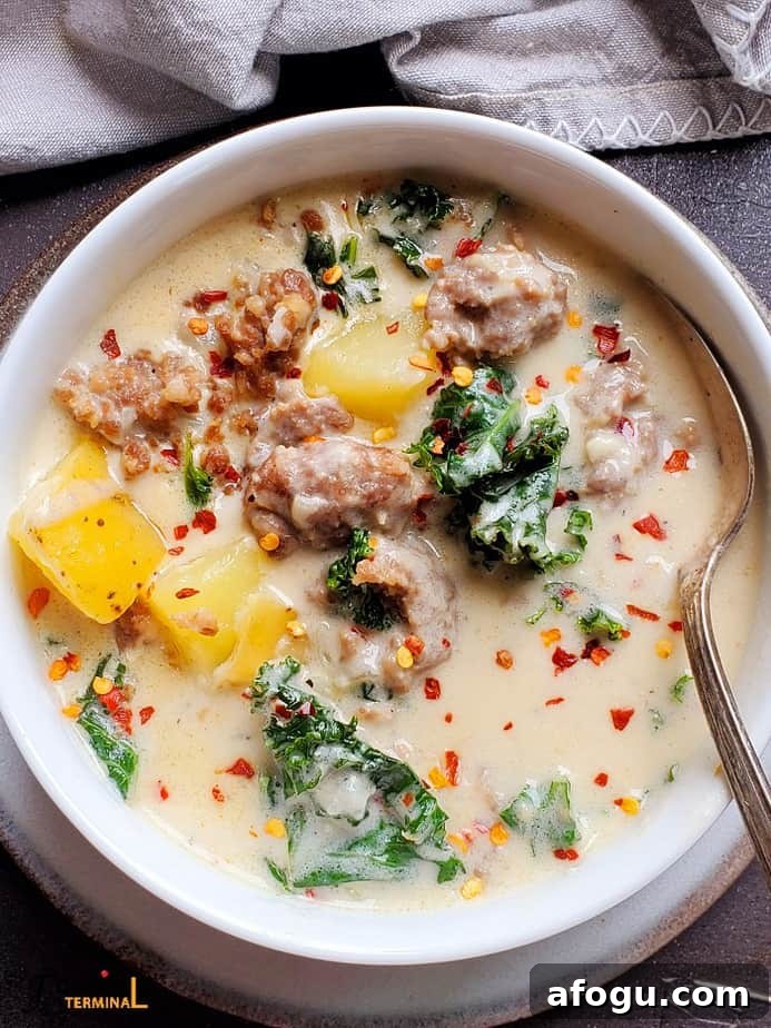 instant pot zuppa toscana soup in white bowl with silver spoon
