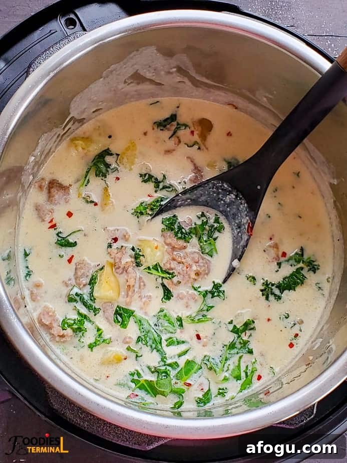 easy instant pot zuppa toscana soup in instant pot with a black ladle