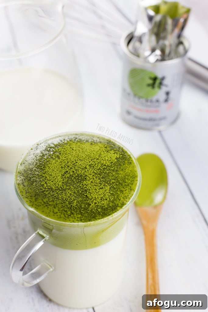 Dalgona Matcha Latte Recipe: Whipped Green Tea Coffeehouse Drink 3 Dalgona matcha latte dusted with some matcha powder.