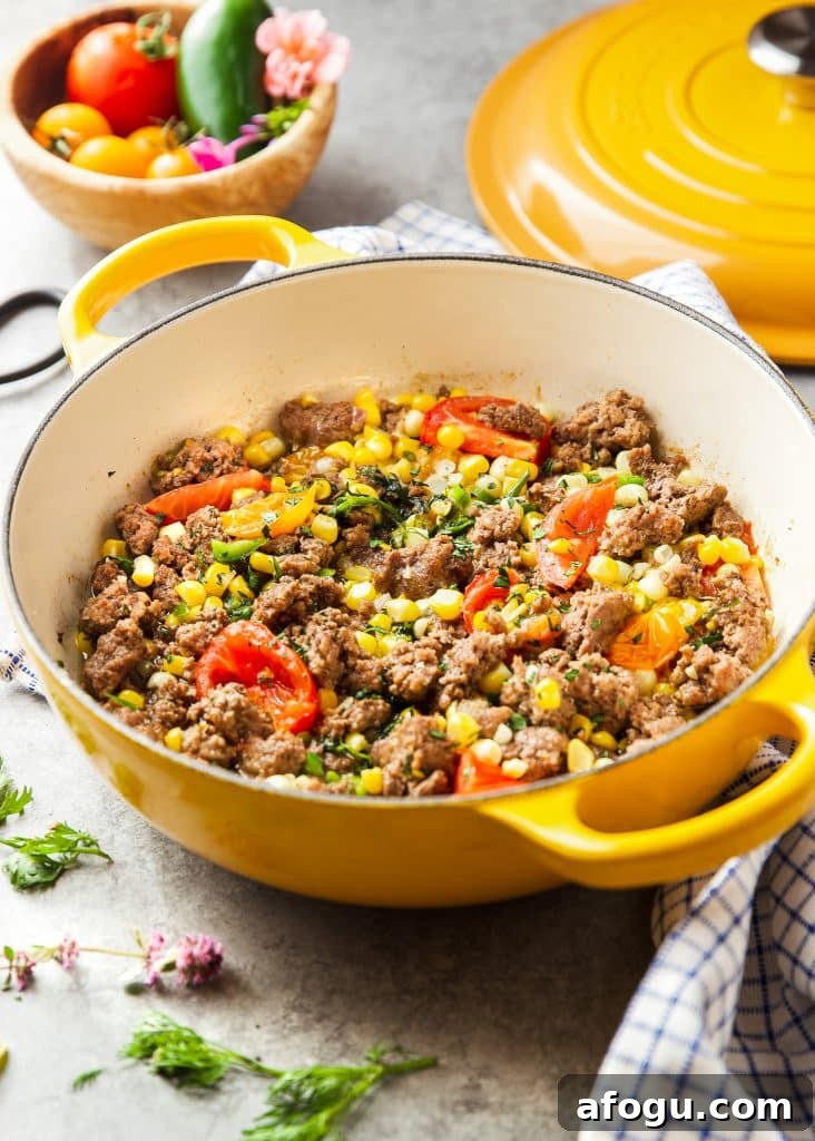 Skillet Ground Beef with Sweet Corn and Bell Peppers 2 ground beef, corn and tomato skillet, garnished with fresh herbs