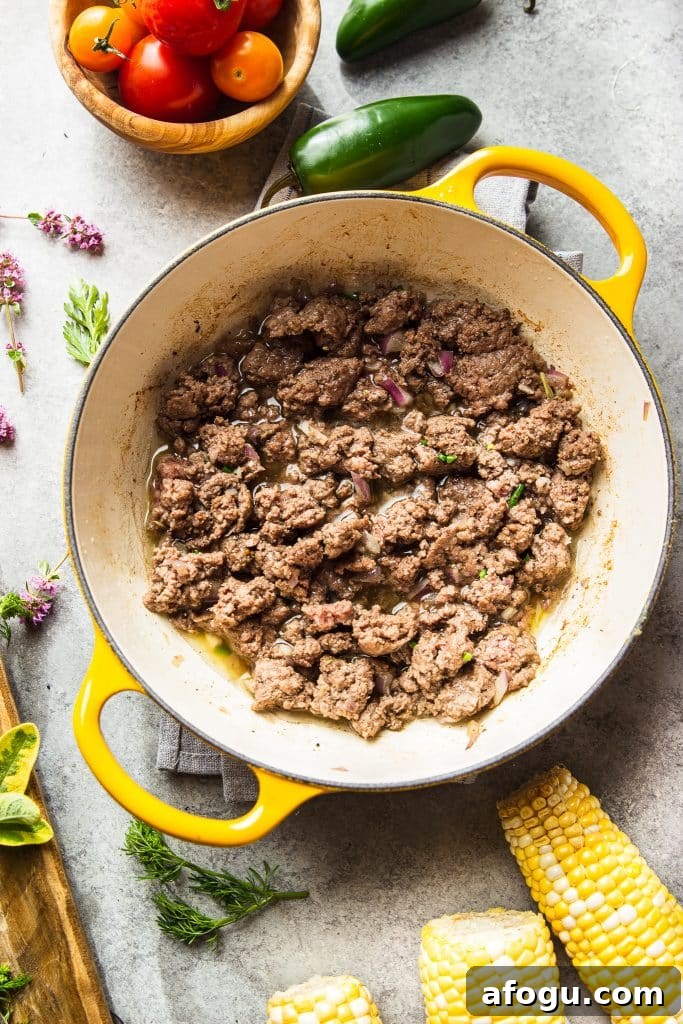 Skillet Ground Beef with Sweet Corn and Bell Peppers 5 cooked ground beef in yellow skillet