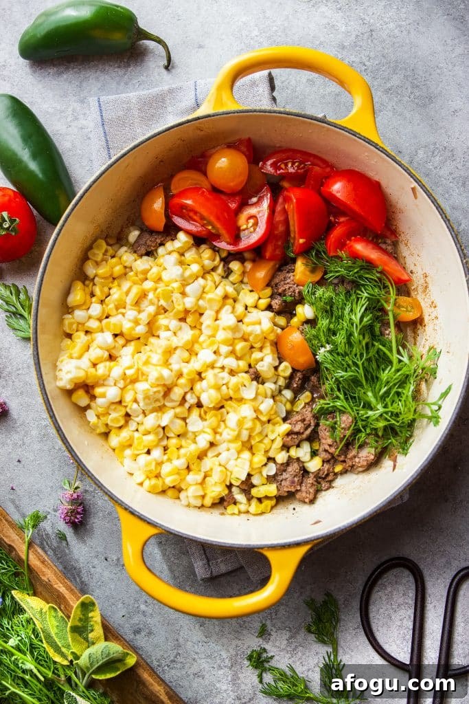 Skillet Ground Beef with Sweet Corn and Bell Peppers 6 ground beef in skillet with corn, tomatoes and fresh herbs
