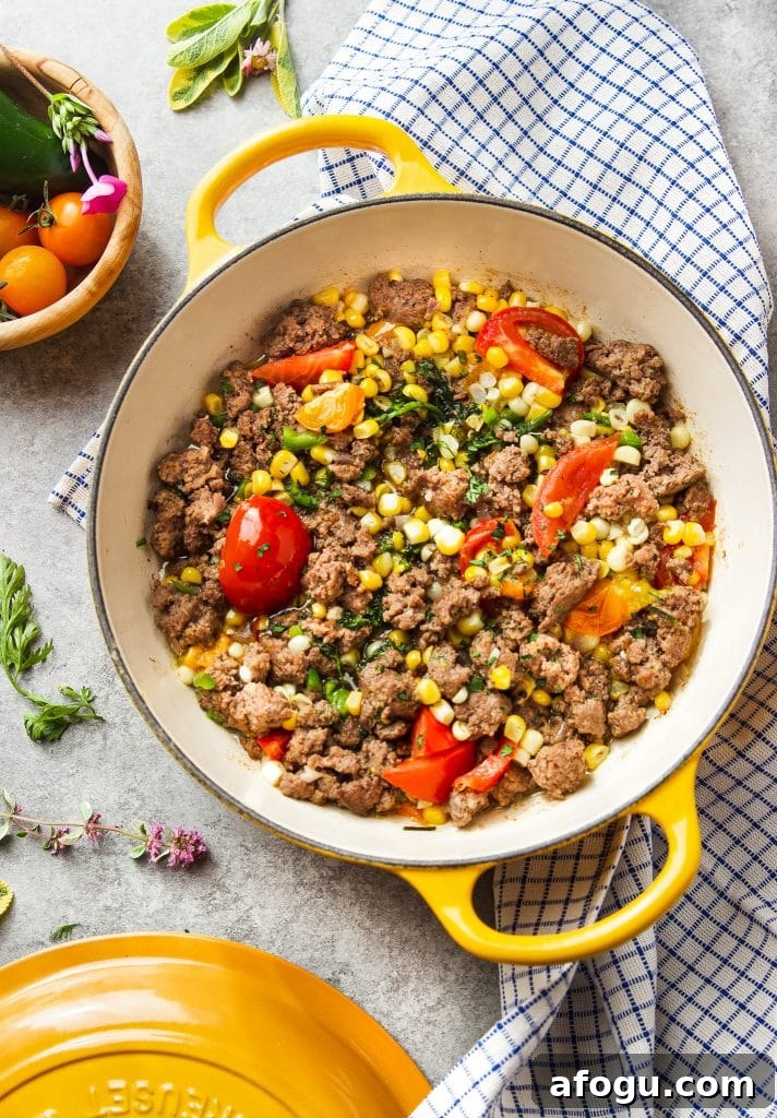Skillet Ground Beef with Sweet Corn and Bell Peppers 7 Ground beef in skillet with corn, tomatoes and fresh herbs