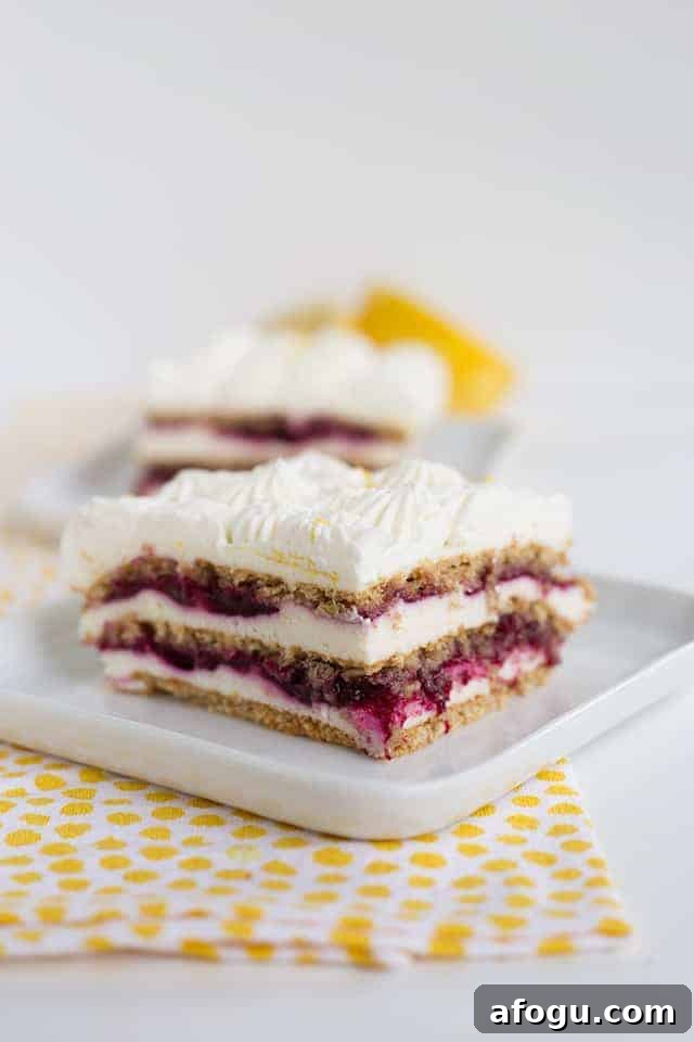 Blueberry lemon icebox cake on a white plate with yellow polka dotted linen