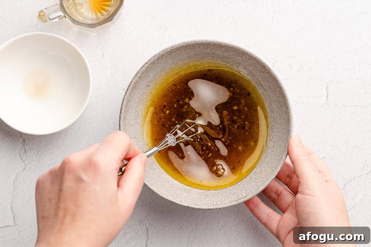 dressing being whisked in small bowl with small dish on the side