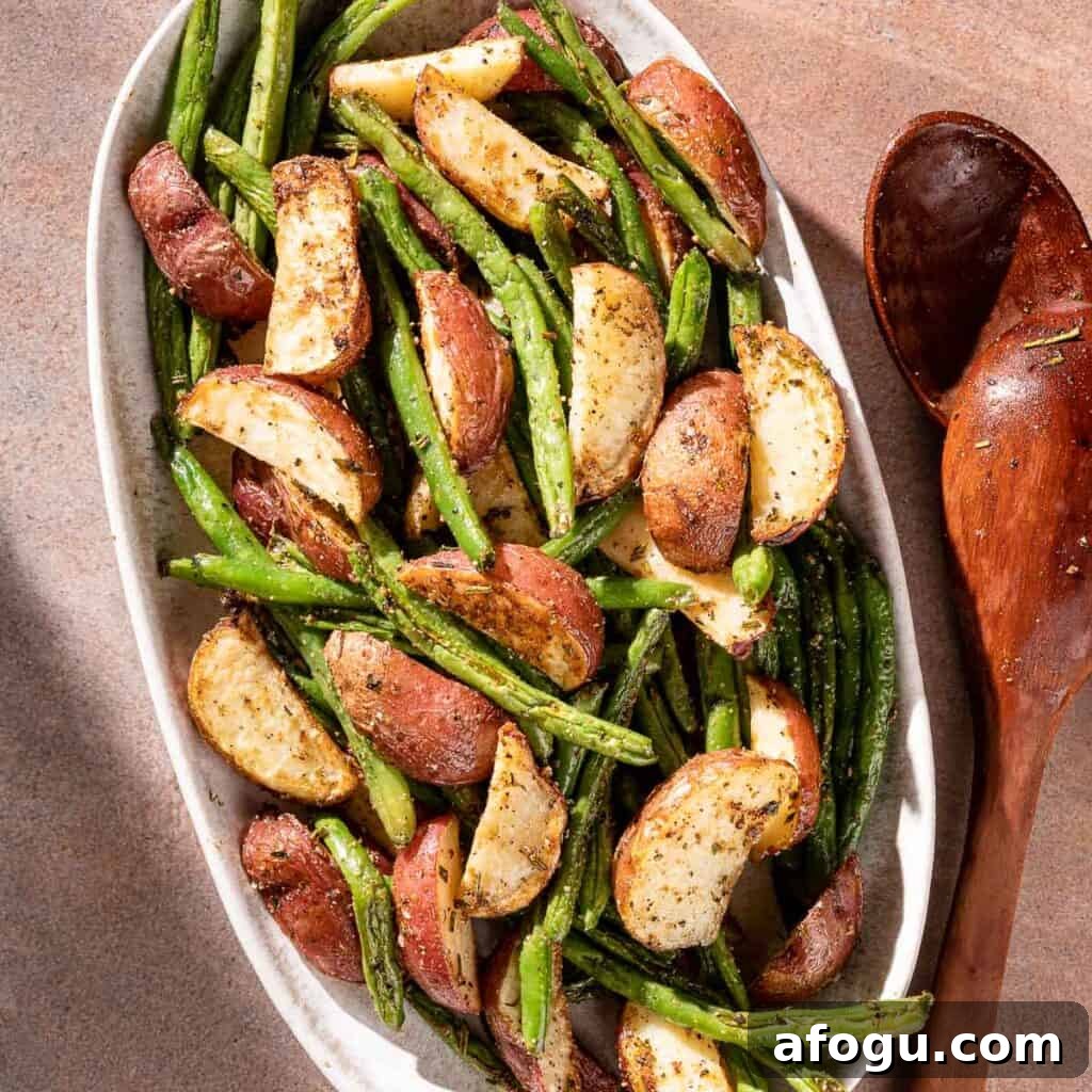 potatoes and green beans on platter with serving spoon on the side
