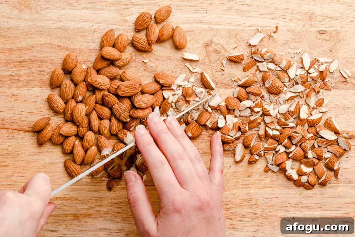 knife chopping almonds into small pieces