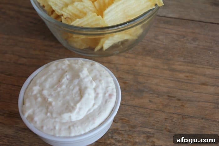 Photo shows a bowl of homemade dip next to a bowl of chips