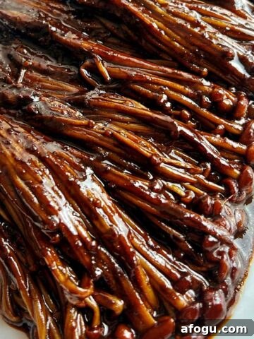 close up of black bean enoki mushrooms