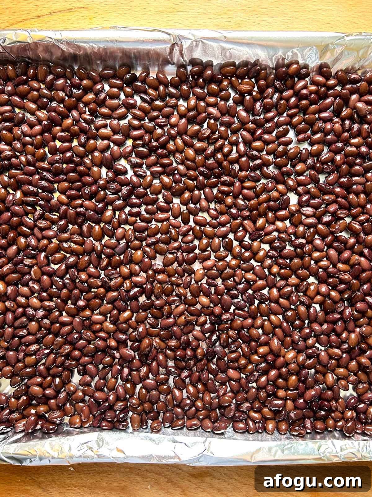 black beans in single layer on baking sheet