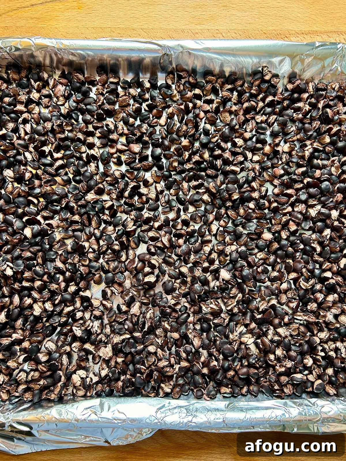 cooked black beans in single layer on baking sheet
