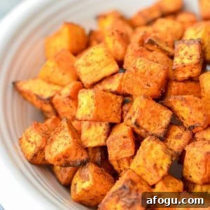Crispy Air Fryer Sweet Potato Cubes Recipe 11 A close up of sweet potato cubes that have been roasted.