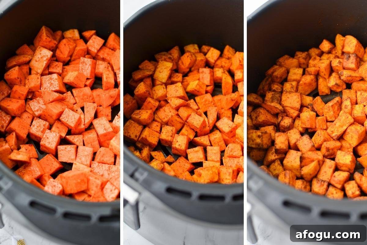 Crispy Air Fryer Sweet Potato Cubes Recipe 7 An air fryer basket with sweet potato cubes at different stages: raw, partially cooked, and fully roasted.