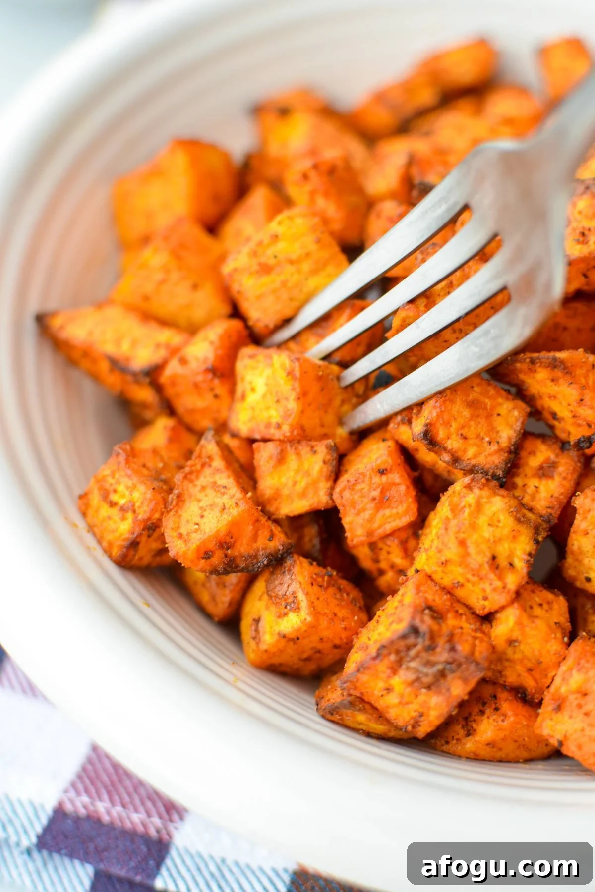 Crispy Air Fryer Sweet Potato Cubes Recipe 10 A fork piercing into a sweet potato cube.