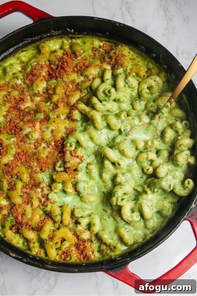 Gold spoon inside gooey green wild garlic mac and cheese.