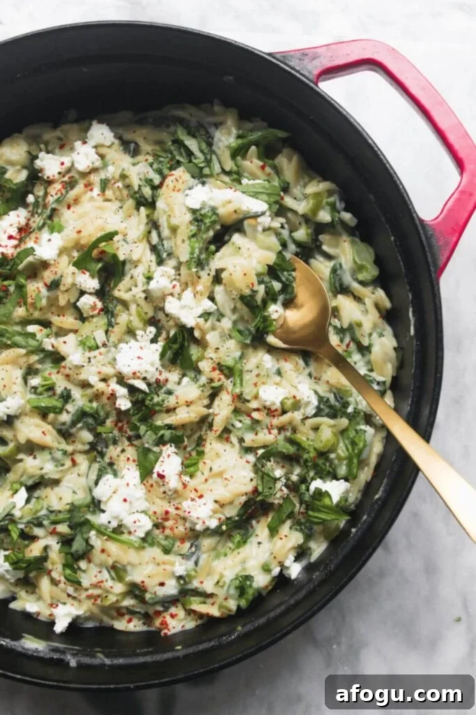 Creamy spinach and feta one pot orzo in a pan.