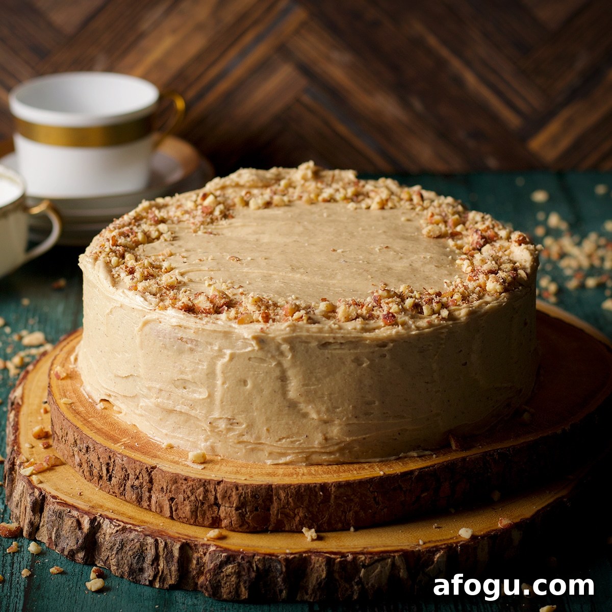 A brown butter cake frosted with maple miso brown butter frosting and sprinkled with chopped roasted almonds.