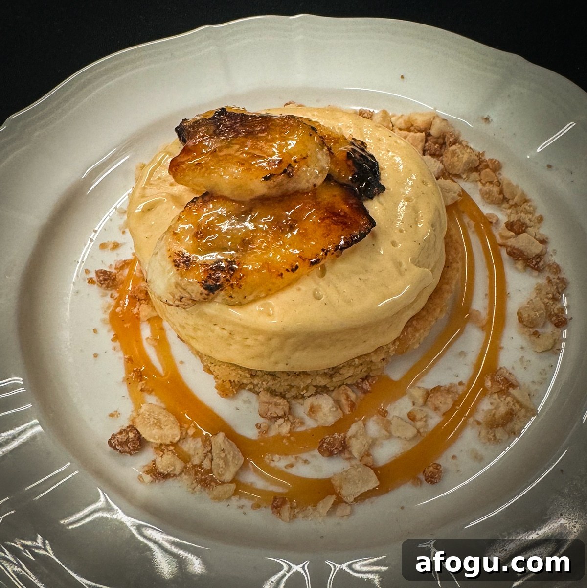 A plate with brown butter cake and other dessert components.