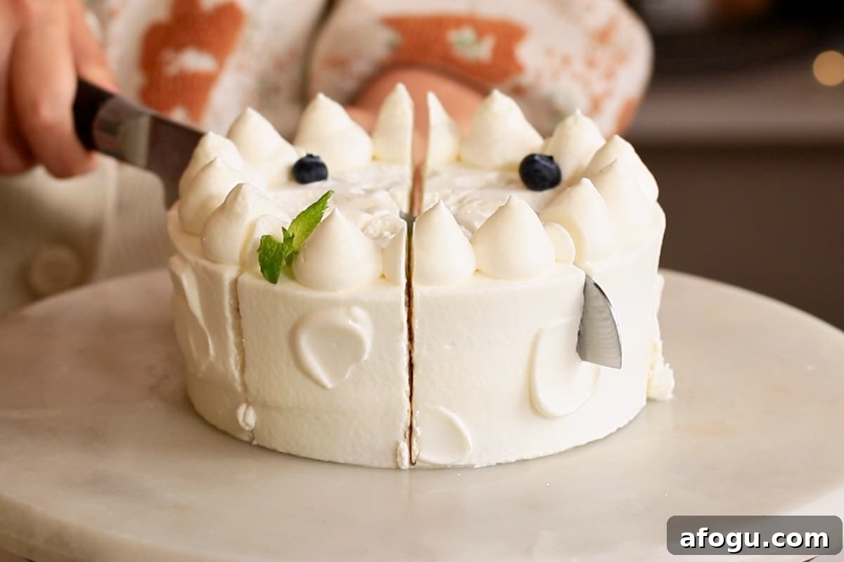 Japanese Strawberry Shortcake Recipe: Fluffy Shortcake with Fresh Strawberries 17 Slicing the fluffy Strawberry shortcake with a serrated knife.