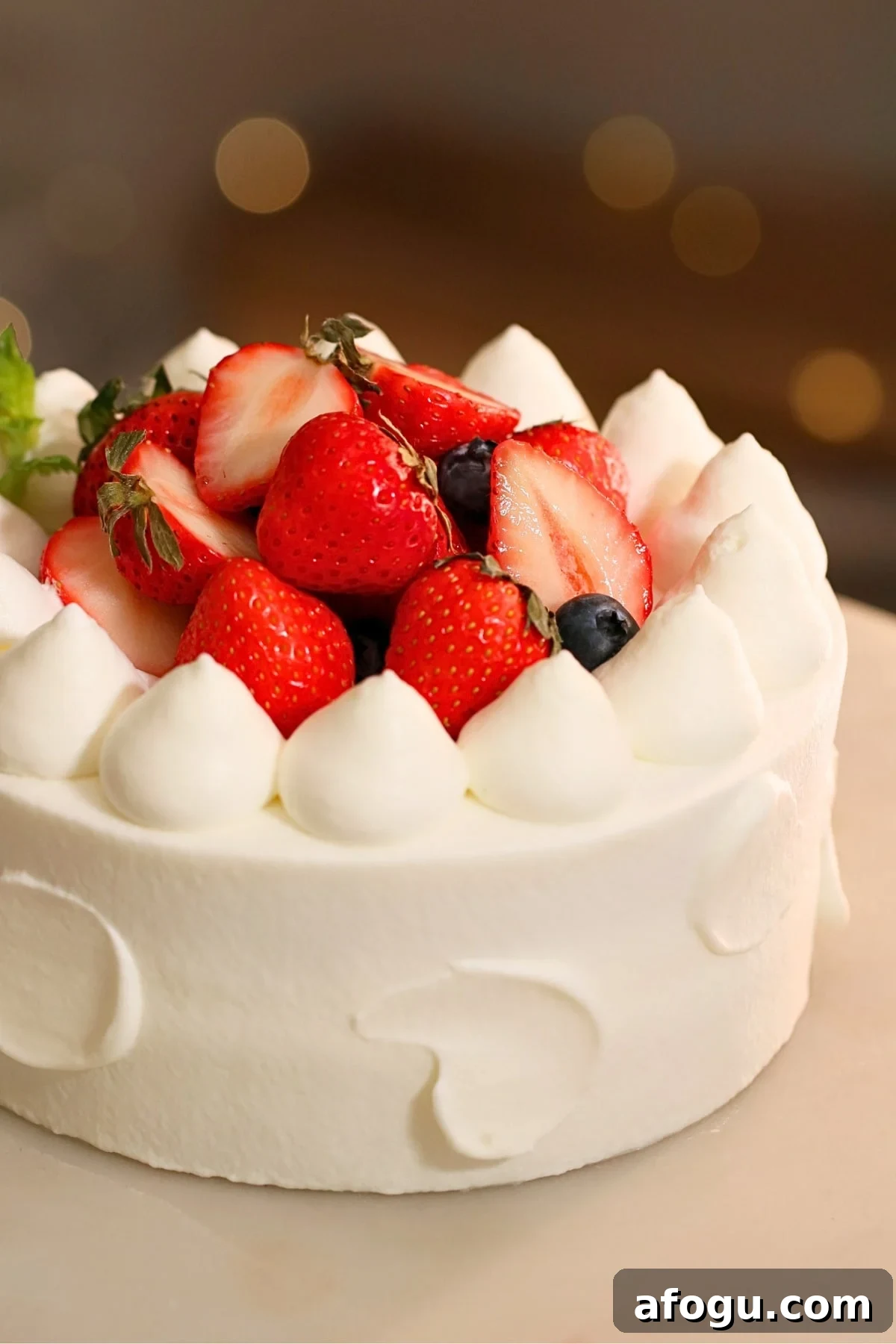 Japanese Strawberry Shortcake Recipe: Fluffy Shortcake with Fresh Strawberries 8 A beautifully decorated Japanese strawberry shortcake on a turntable.