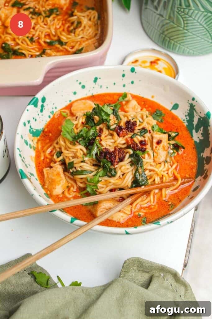 Saucy satay ramen in a bowl, with chopsticks.