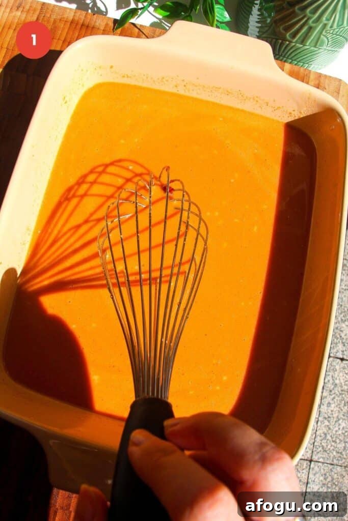 Whisking satay peanut sauce in an oven dish.