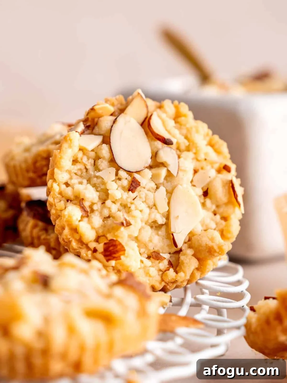 A shortbread cookie with almond filling and sliced almonds on top.