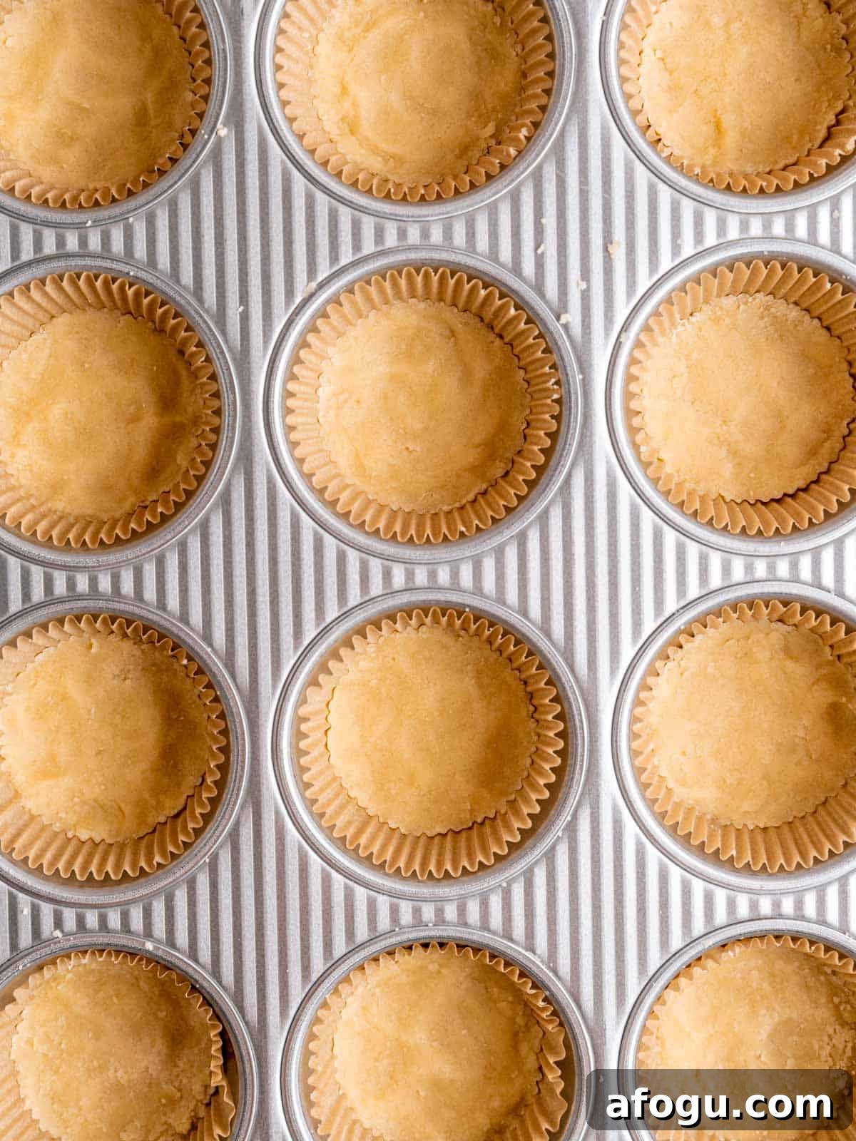 Shortbread cookie dough pressed into muffin liners.