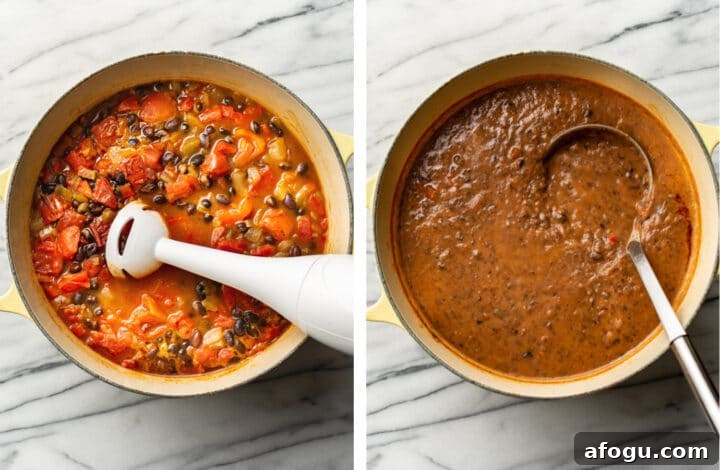 using an immersion blender to puree black bean soup