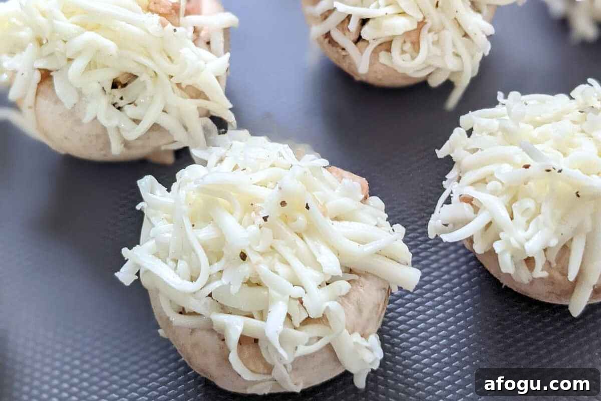Delicious cheesy mushrooms on a board