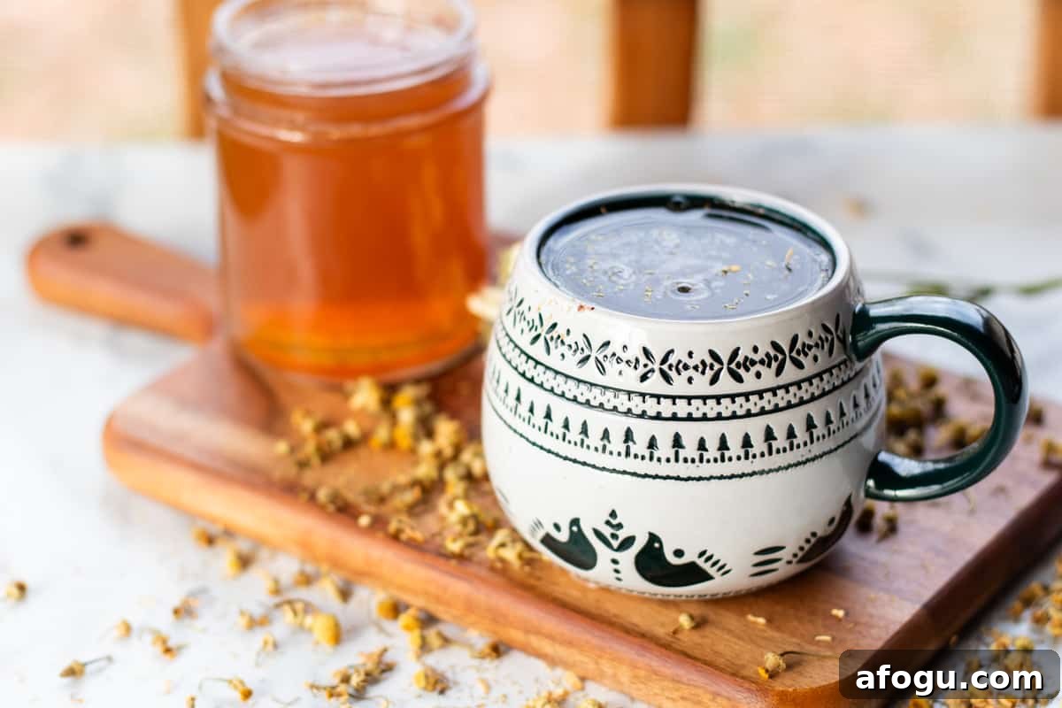 Chamomile tea hand soak cooling down in a mug.