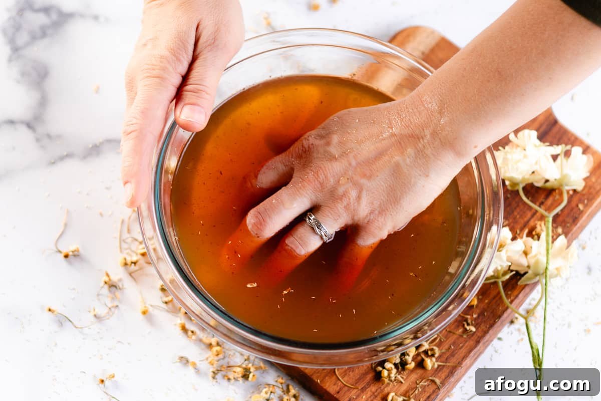 Soaking hands in a DIY hand soak recipe.