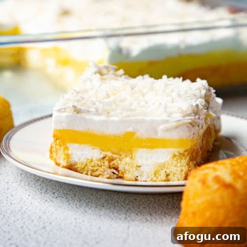 slice of twinkie cake on a white plate, next to a whole twinkie.