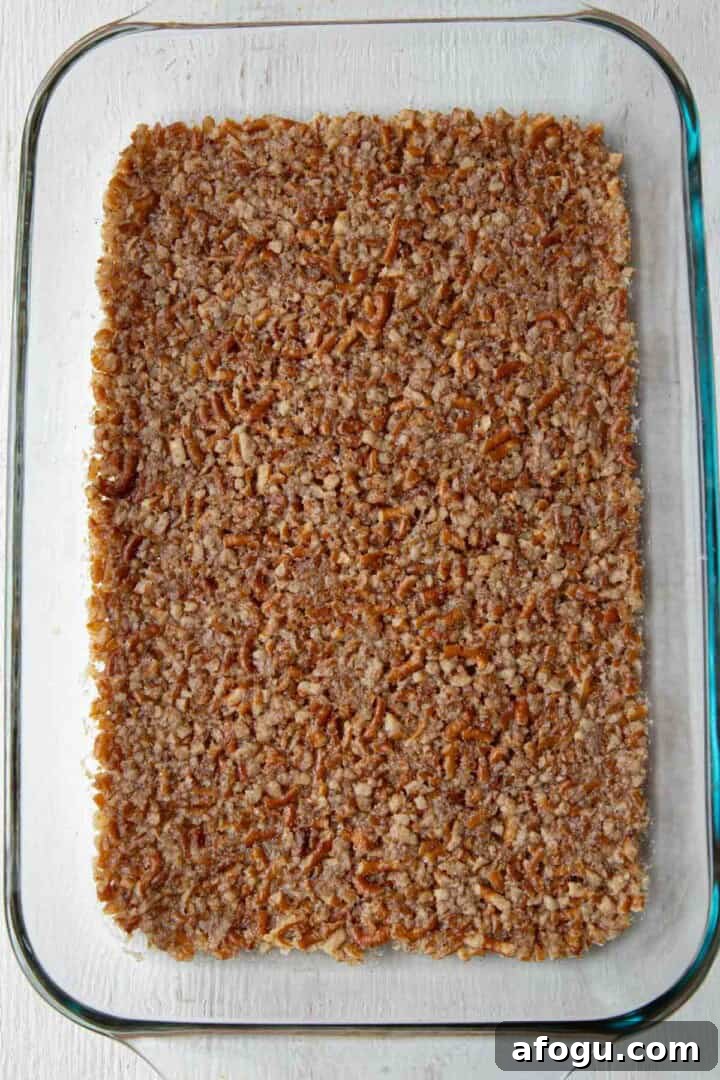 cooked pretzel crust in a baking dish.