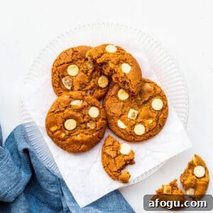 A plate of ginger cookies with white chocolate chips.