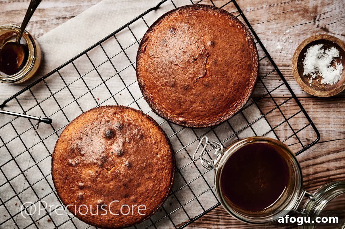Two 8-inch cakes, cooling on a cooling rack.