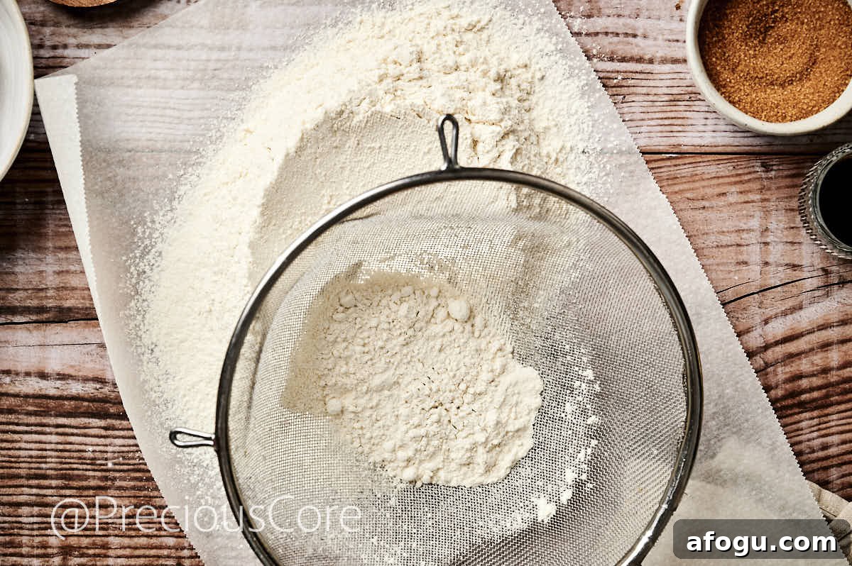 Sifting flour with a fine mesh sieve.