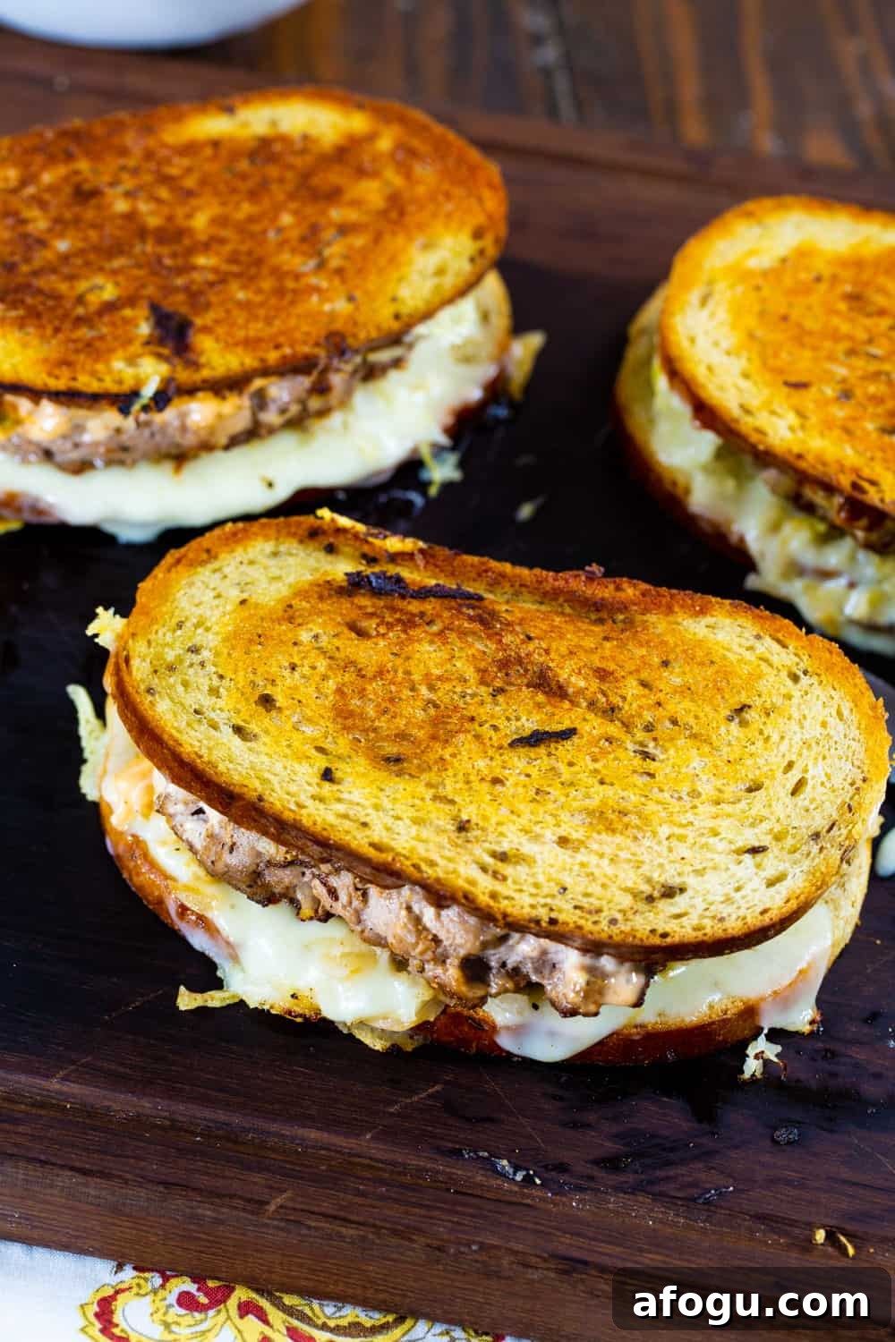 Turkey Reuben Patty Melt with Turkey Burger Patties 3 Three Patty Meltes on a cutting board.