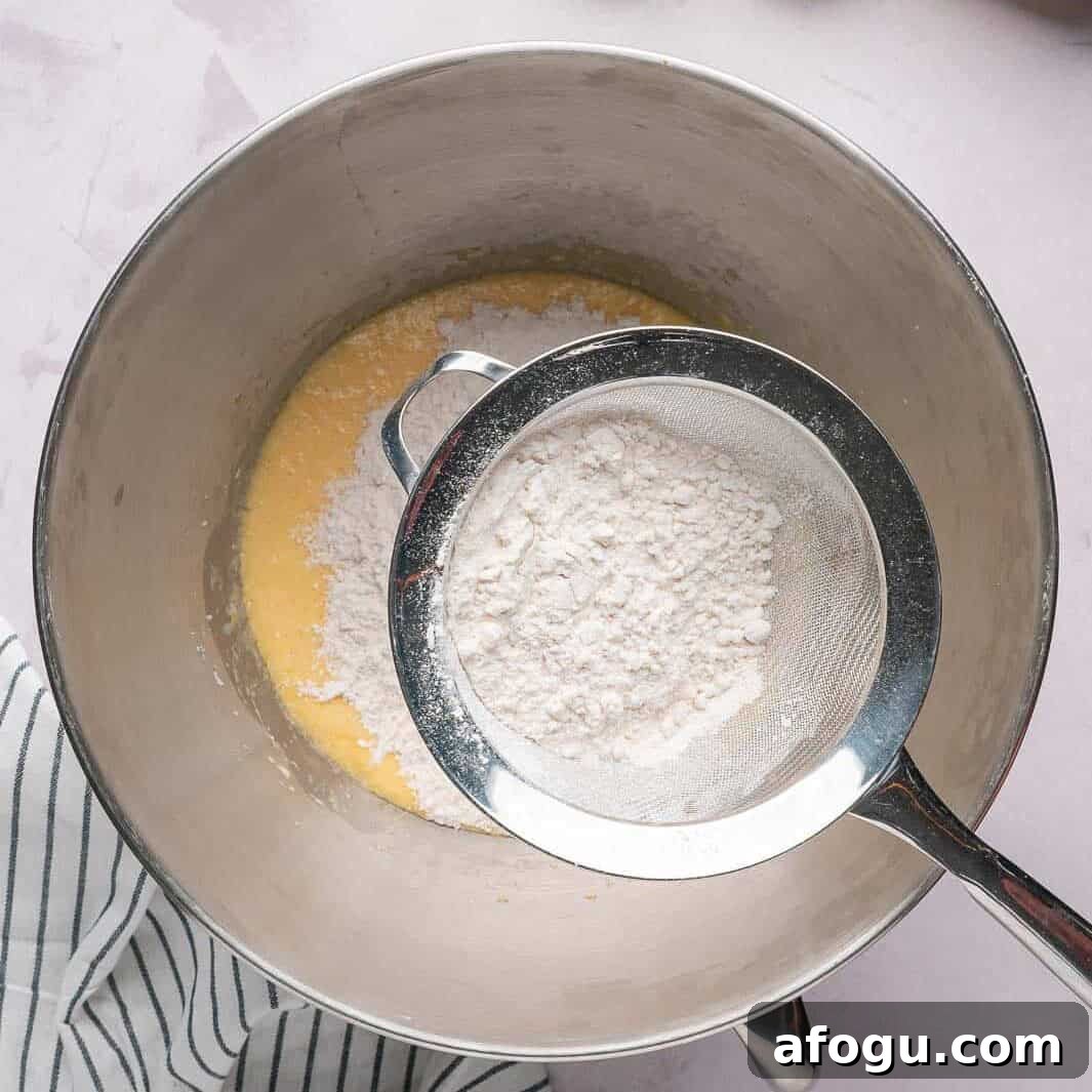 Moist Pear Cake Recipe — 20-Minute Prep, Simple Steps 7 Sifting all-purpose flour and baking powder into the wet ingredients to ensure a tender pear cake crumb without overmixing.
