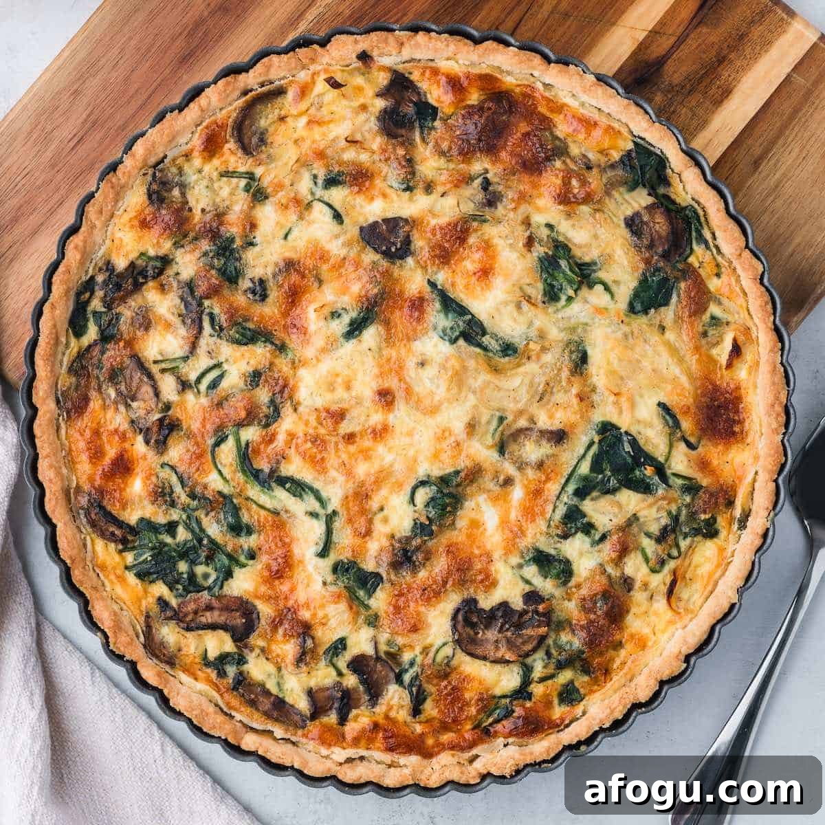 Spinach Mushroom Quiche Recipe — Flaky Crust, Creamy Filling 19 A mushroom and spinach quiche in a tart pan.