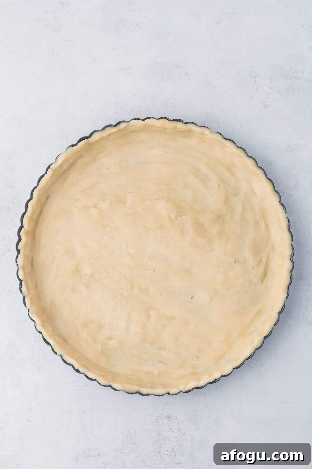 Spinach Mushroom Quiche Recipe — Flaky Crust, Creamy Filling 7 Uncooked pie crust in a tart pan.
