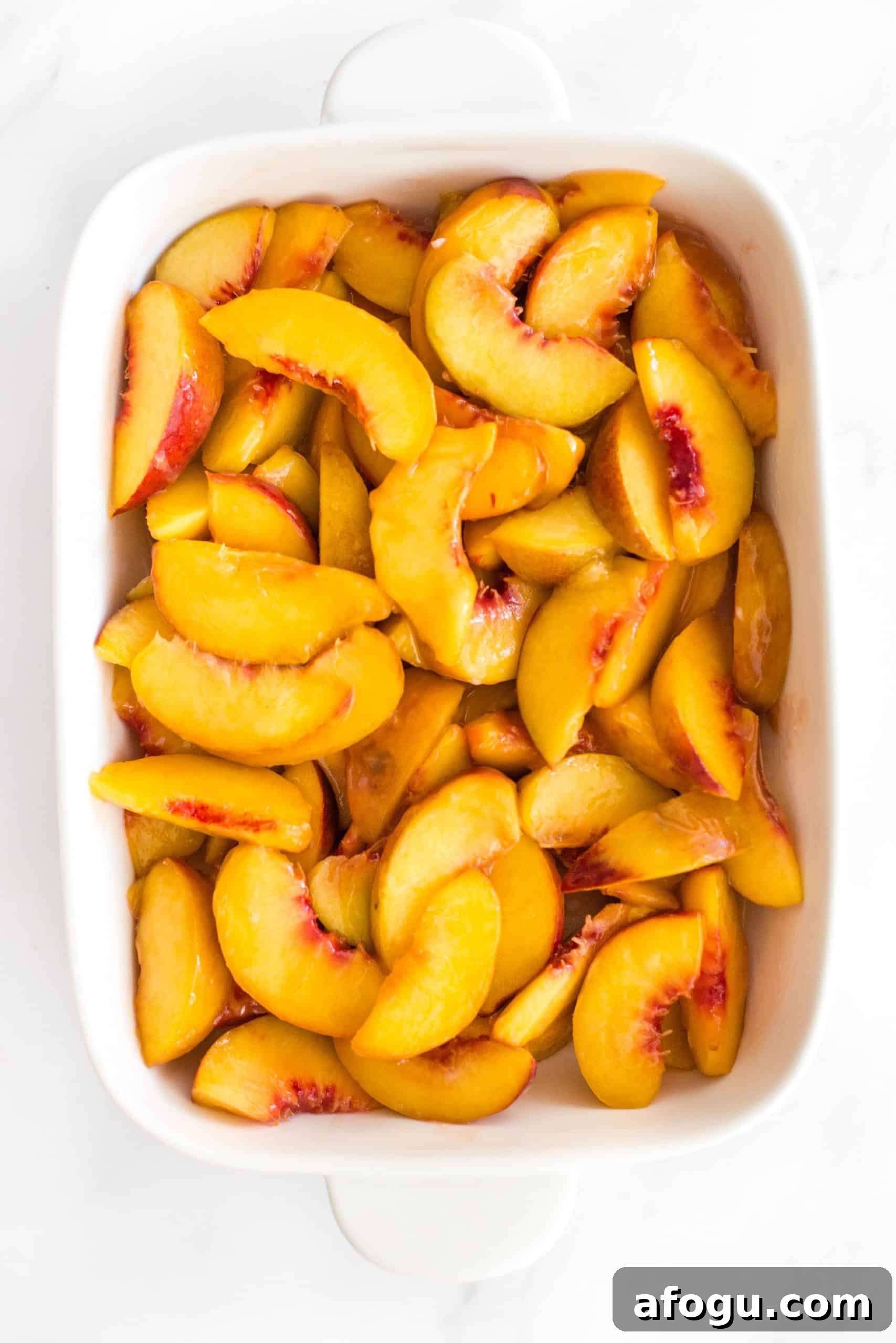 Easy Gluten-Free Peach Cobbler Recipe (Dairy-Free, Vegan) Peach filling in a baking dish.