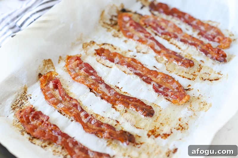 cooked bacon on a baking sheet